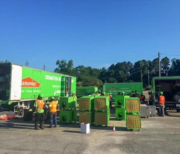 SERVPRO techs unloading trucks in the parking lot of a DeKalb County business
